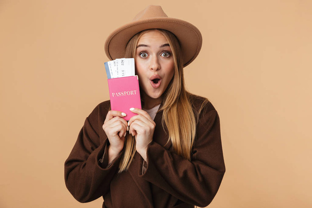 Image of optimistic girl wearing hat holding passport and travel - 写真・画像