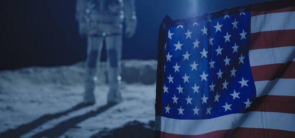 Astronaut standing behind US flag - Fotografie, Obrázek