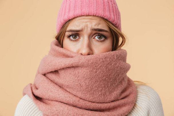 Image of girl wearing winter hat and scarf frowning and being up - Foto, Bild
