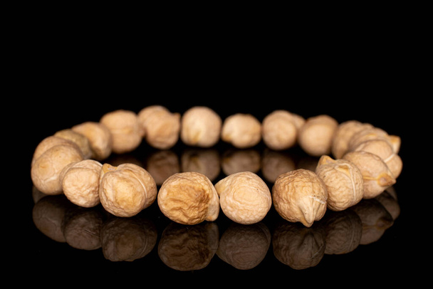 Fresh tan chickpea isolated on black glass - Photo, image