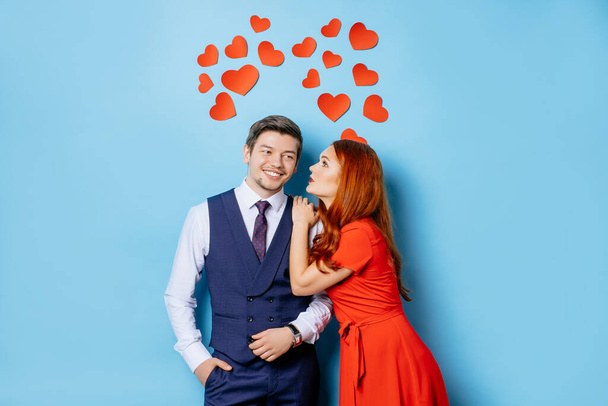 happy caucasian couple in love isolated over blue background - Zdjęcie, obraz