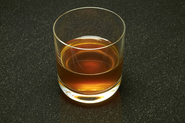 alcohol is tempting on a black marble slab. - Foto, Bild