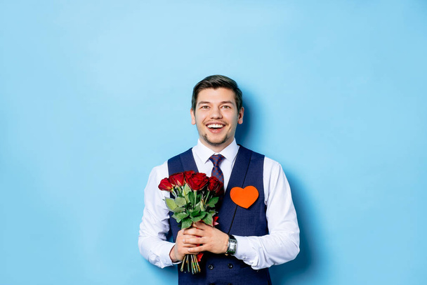 surprised caucasian guy with flowers isolated - Photo, image