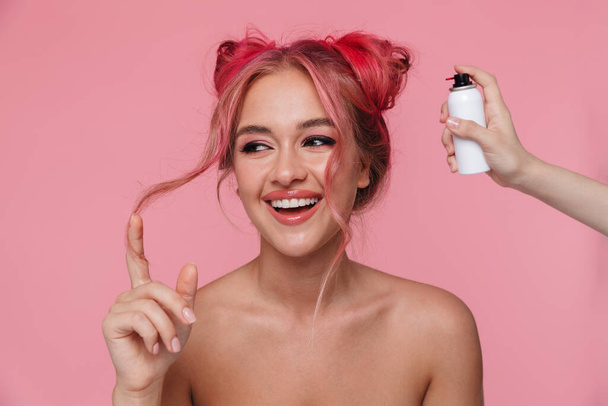 Portrait of joyful woman smiling and dying her hair with color s - Photo, Image