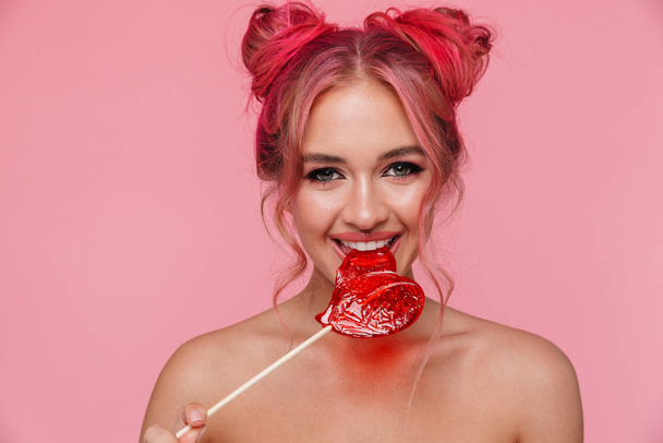 Portrait of beautiful shirtless young woman eating sweet lollipo - Fotó, kép