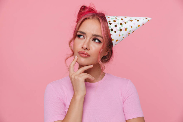 Portrait of woman with colorful hairstyle wearing party cone thi - Фото, зображення