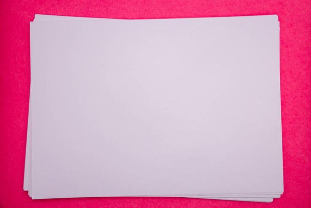 blank sheet of paper on pink background. Paper page with curl. - Φωτογραφία, εικόνα