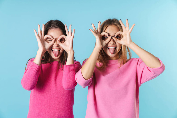 Photo of excited pretty women making fun and gesturing ok sign - Foto, afbeelding