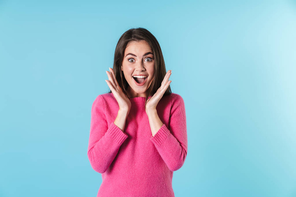 Photo of excited brunette woman expressing surprise and smiling - Foto, imagen