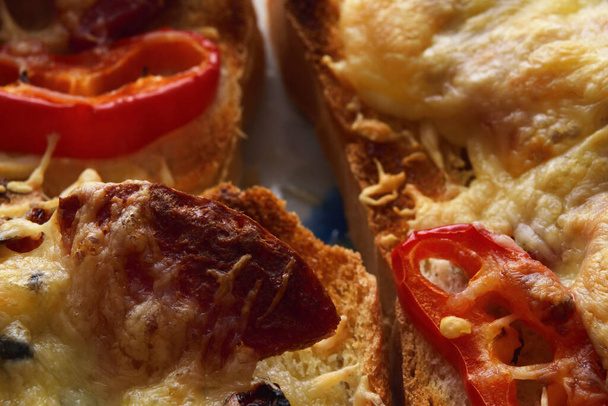 Slice of fried sausage on toast with cheese and peppers - Photo, Image