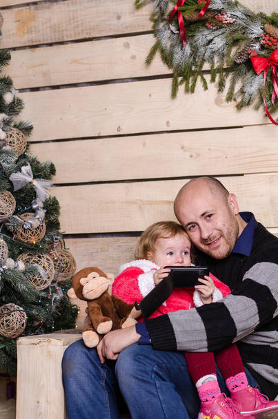 happy father with little daughter with Christmas tree - Фото, изображение