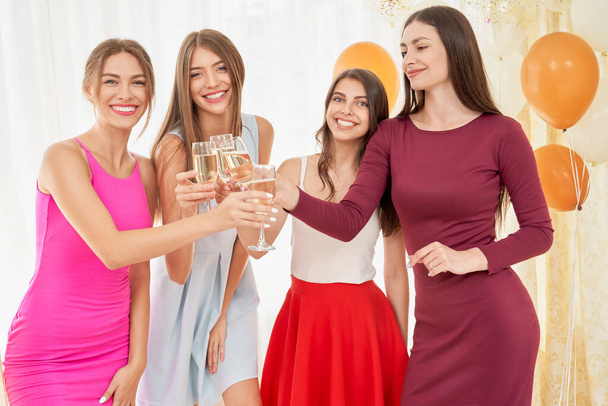 Girlfriends drinking wine at home party. - Foto, Bild