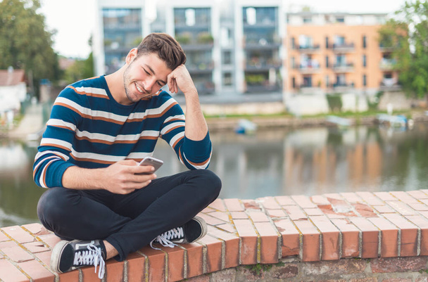 Positive male happy to recieve pleasant message from female - 写真・画像