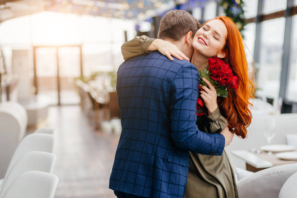 lovely redhaired lady and handsome guy on a date - Photo, Image