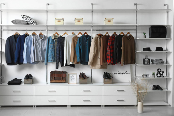 Modern wardrobe with stylish winter clothes and accessories - Photo, Image