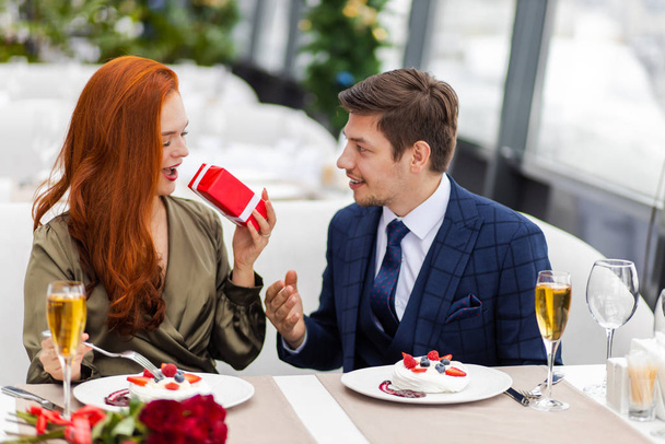 leisure, celebration, food and drinks. couple celebrate their anniversary - Фото, изображение