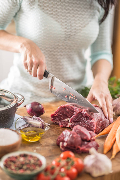 Young housewife slicing fresh beef steak. Female hands preparing - Photo, image