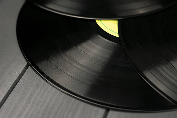 Traditional black vinyl records on gray wooden table - Photo, Image