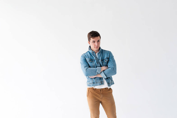Young handsome man dressed in Blue jeans jacket  - Фото, зображення