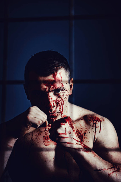 Psycho mad man. Psychic disease. Murderer brutal aggressive guy. Fight and attack. Aggressive person. Strong aggressive monster behind grid. Bodybuilder nude torso soiled blood. Prison for monster - Zdjęcie, obraz