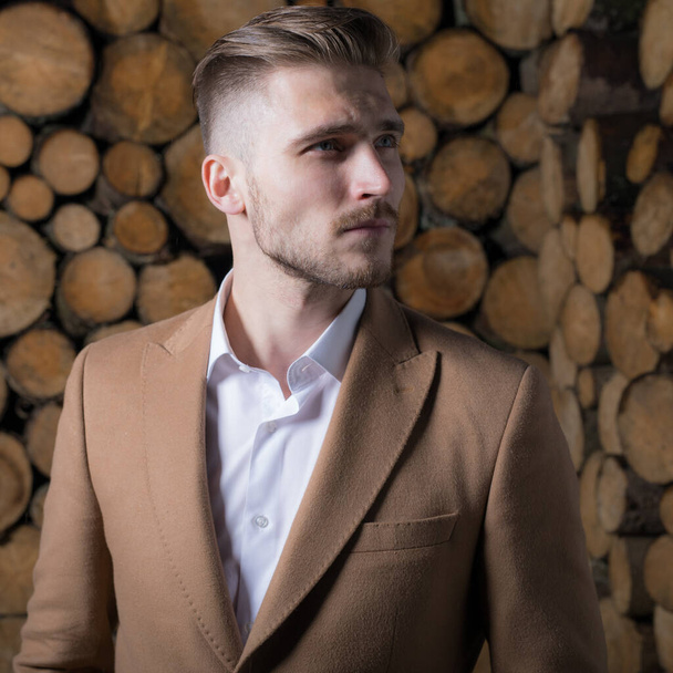 Portrait of handsome young man on wooden background. - Foto, Imagem