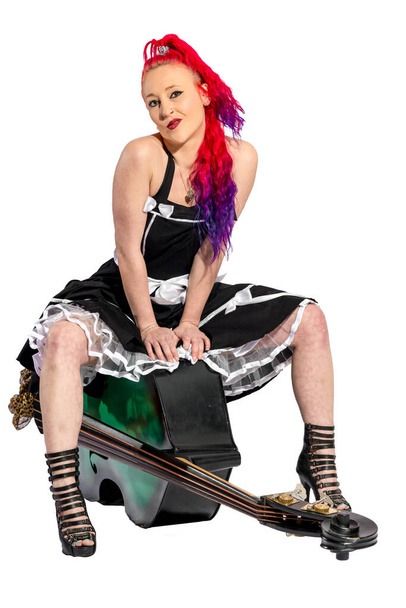 rock'n'roll singer with red hair sits on a double bass - Φωτογραφία, εικόνα