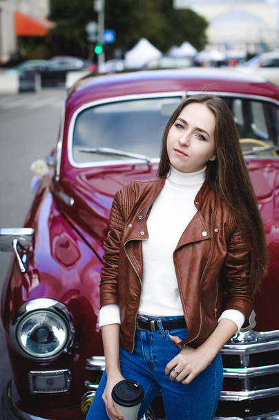 street portrait of a female student girl in fashionable clothes, blue jeans and a brown jacket - Foto, Bild