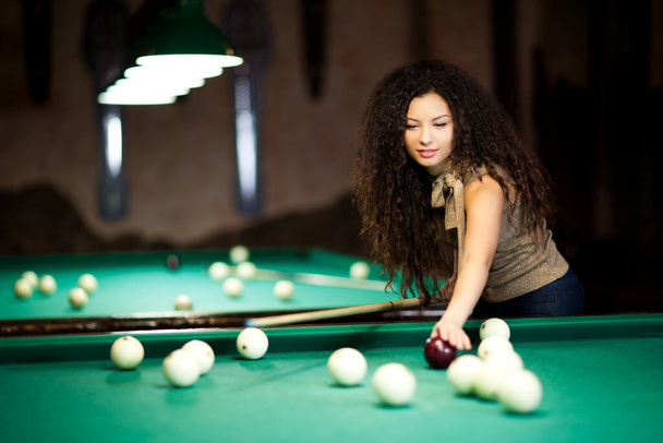 Beautiful girl playing billiards - Foto, immagini