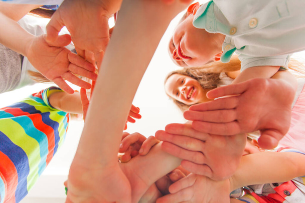 Children play together, putting their arms together - Фото, зображення