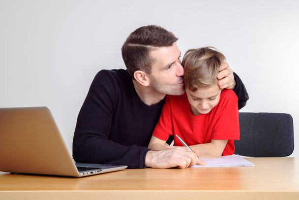 father helping his son with homework at table - Fotoğraf, Görsel