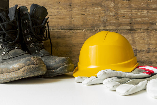 Equipment safety standard. Yellow hard hat, construction boots and gloves. - Valokuva, kuva
