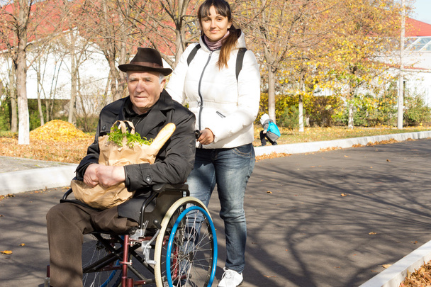 Woman helping her senior handicapped father - Photo, Image