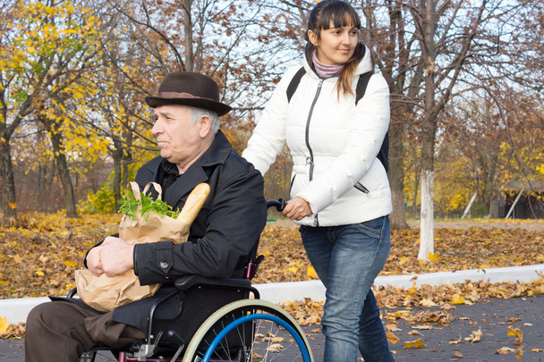 Happy woman helping a handicapped man - 写真・画像
