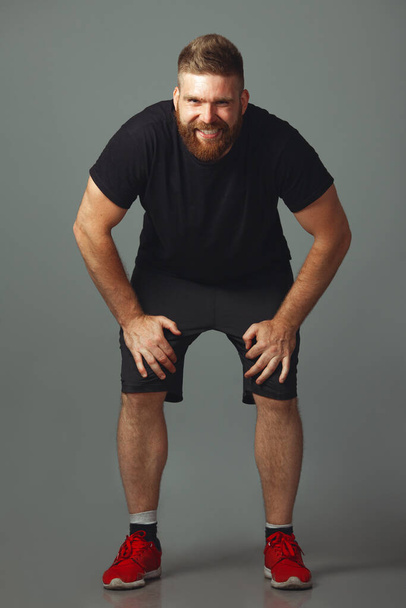 Sportswear concept. Full length portrait of sweet smiling charismatic man - Fotografie, Obrázek