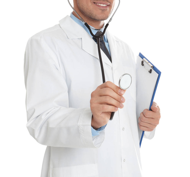 Doctor with clipboard and stethoscope on white background, close - Fotografie, Obrázek