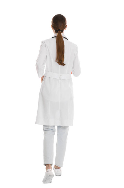 Doctor in robe walking on white background - 写真・画像