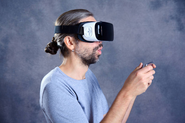 young man with virtual reality glasses playing game - 写真・画像