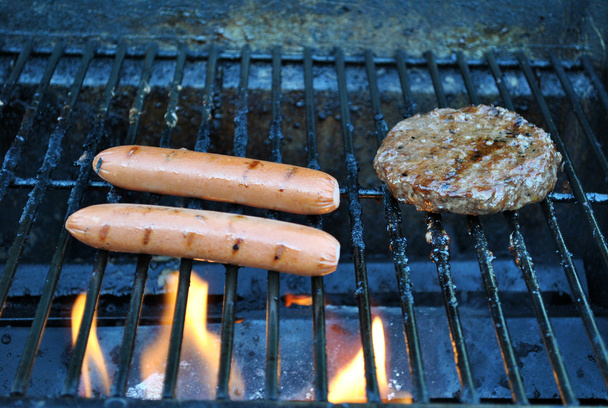 Hotdogs and hamburger grilling - Photo, Image