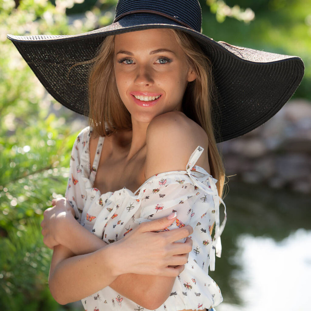 Portrait of beautiful young girl in summer garden. - Fotó, kép