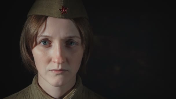 Video of young woman in sorrow wearing soviet red army uniform - 映像、動画