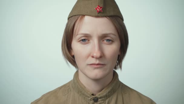Video of woman wearing soviet red army uniform on white - 映像、動画