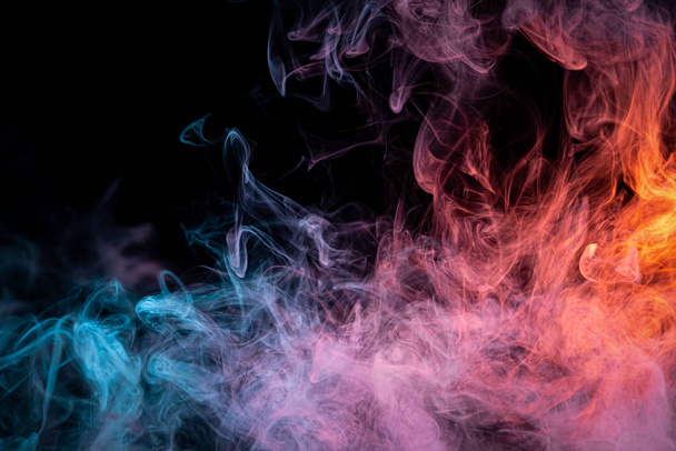  Red and  blue  cloud smoke on black  isolated background. Fog colored with bright pink gel on dark background - Φωτογραφία, εικόνα