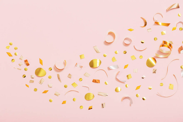 golden  confetti on pink background - Foto, Imagem