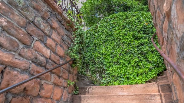 Panorama Close up of outdoor stairs amid stone brick retaining walls that leads to a home - Photo, Image