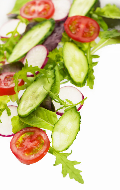 Cut cucumbers, garden radish, tomatoes and lettuce leaves - Photo, Image