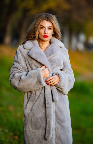 Sexy woman red lips wear fur coat. Businesswoman in fur coat. Simple and warm. Glamorous lady. Cosy autumn outfit. Winter fashion trends. Luxury segment brand. Fur boutique. Soft jacket furry texture - Foto, immagini