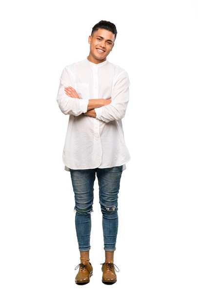 A full-length shot of a Young man keeping the arms crossed in frontal position over isolated white background - Foto, afbeelding