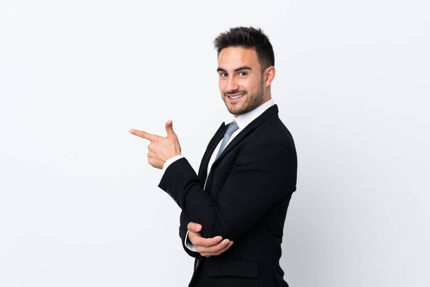 Young business man over isolated background pointing finger to the side - Foto, imagen