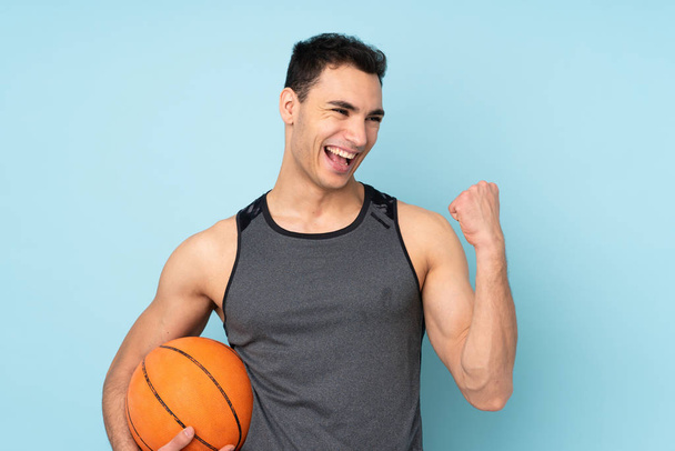 男オン孤立した青の背景演奏バスケットボール - 写真・画像