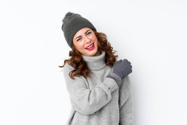 Young Russian woman with winter hat over isolated white background celebrating a victory - 写真・画像